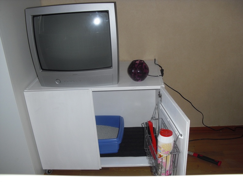 A litterbox cabinet I made a couple of years ago, from a piece of my daughter's old bookshelf. Ikea/Ivar.
I don't have it any longer but it's an Idea. 20100803-kattladeskap-02.jpg